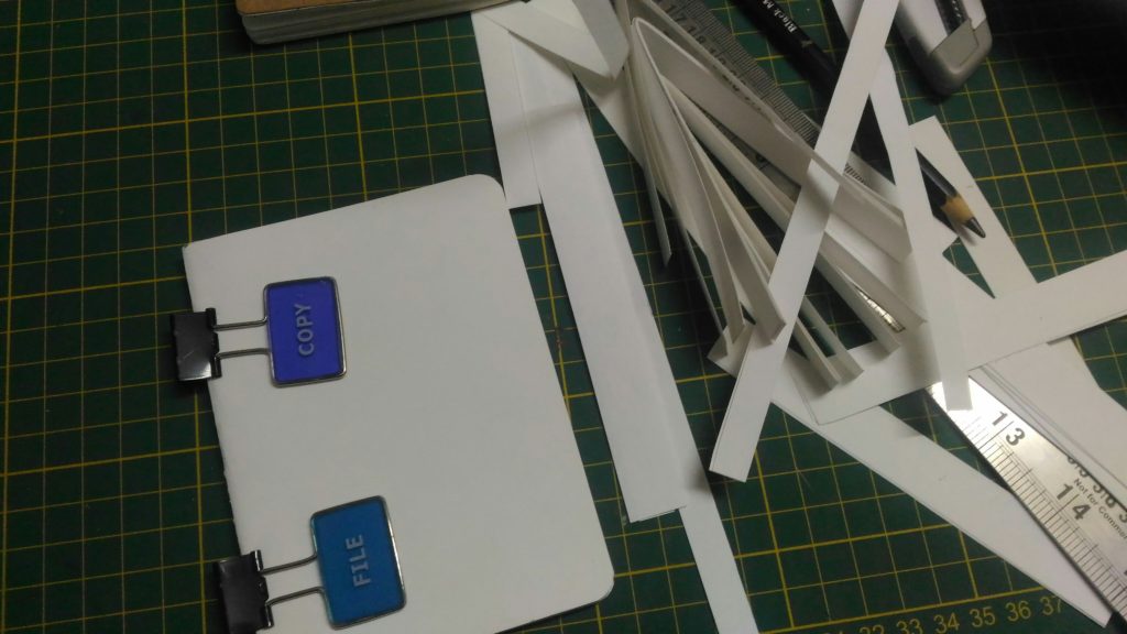 I have attached the external wrapper and stuck it using gum. I used standard cutter and steel scale to cut the notebook.